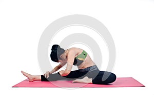 Beautiful woman indoor exercising using pink yoga mat