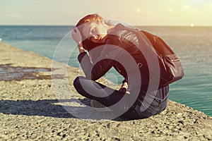 Beautiful woman in jeans and jacket. Sea