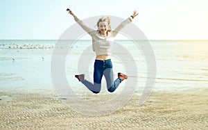 Beautiful woman jeans sweater jumping laughing