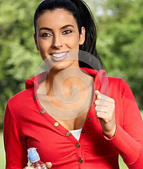 Beautiful woman jogging in citypark smiling photo