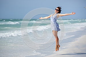 Beautiful woman jumping on Florida Beach photo