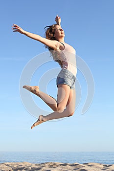 Beautiful woman jumping happy on the beach