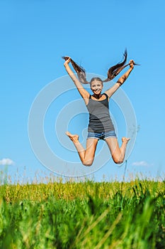 Beautiful woman jumps high into sky