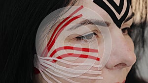 Beautiful woman with kinesio tapes on her forehead and cheeks against wrinkles, facelift beauty procedure. Kinesiology treatment