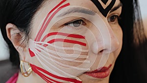 Beautiful woman with kinesio tapes on her forehead and cheeks against wrinkles, facelift beauty procedure. Kinesiology treatment