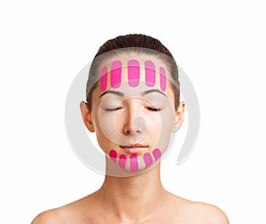 Beautiful woman with kinesiology facelift tapes. photo