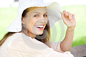 Beautiful woman laughing with sun hat