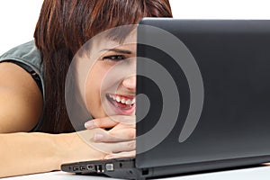 Beautiful woman laughing and watching a netbook computer