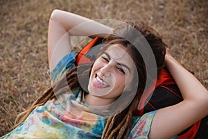 Beautiful woman lay on grass looking camera enjoy the traveling