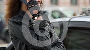 Beautiful woman in leather jacket smiling and talking on the phone, conversation