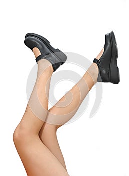 Beautiful woman legs and black shoes pointing up isolated on a white background