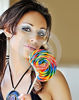 Beautiful woman licking lollipop