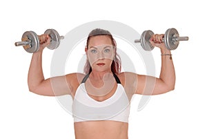 Beautiful woman lifting the two dumbbells up