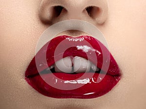 Beautiful woman lips with red lipstick closeup