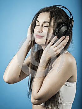 Beautiful woman listening to music with headphones