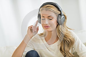 Beautiful Woman Listening To Music Through Headphones