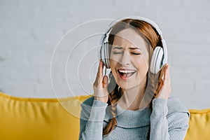 Beautiful woman listening to music and singing