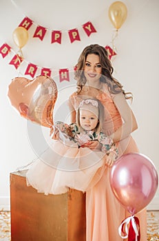 Beautiful woman with little girl celebrating birthday party