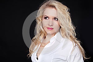 Beautiful woman with long blond hair isolated on black background
