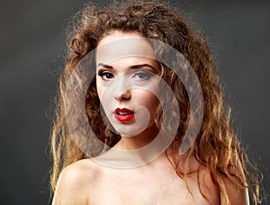 Beautiful woman with long brown hair. Closeup portrait of a fashion model posing at studio.