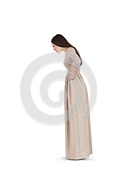 Beautiful woman in long dress staring