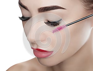 Beautiful Woman with long eyelashes in a beauty salon. Eyelash extension procedure.