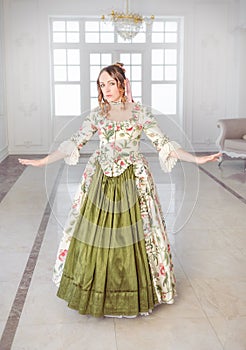 Beautiful woman in long green medieval dress