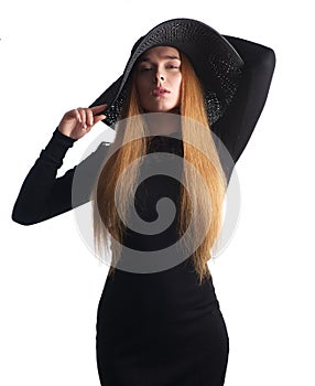 Beautiful woman with long hair and black hat isolated on white