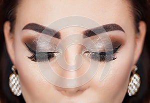 Beautiful Woman with long lashes and beautiful make-up in a beauty salon.