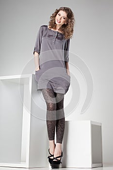 Beautiful woman with long legs dressed elegant posing in the studio - full body