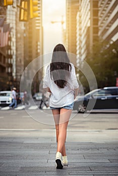 Beautiful woman with long legs walking around New York City street