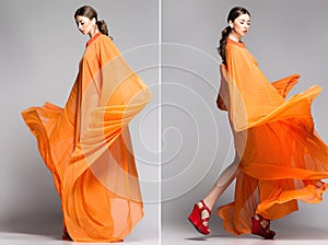 Beautiful woman in long orange dress posing dramatic