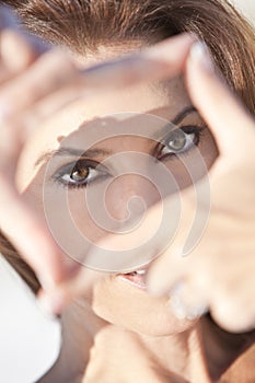 Beautiful Woman Looking Through A Finger Frame