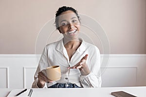 Beautiful woman looking and speaking through the web camera while making a video conference from office or home.