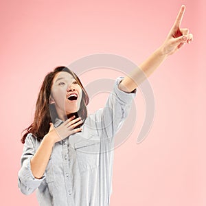 Beautiful woman looking suprised isolated on pink