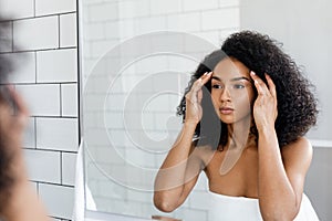 Beautiful woman looking in to mirror