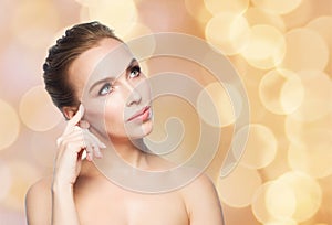 Beautiful woman looking up over holidays lights