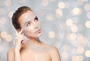 Beautiful woman looking up over holidays lights