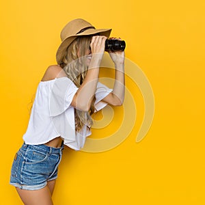 Beautiful Woman Looks Through Binoculars