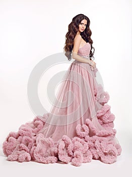 Beautiful woman in luxury lush pink dress. Fashion lady brunette