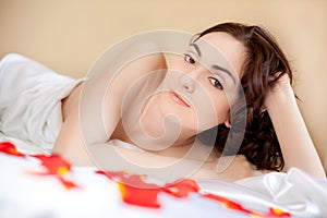 Beautiful woman lying in bed