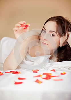 Beautiful woman lying in bed and looking