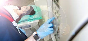 beautiful woman lying on ct scanner bed during tomography test in hospital