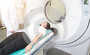 beautiful woman lying on ct scanner bed during tomography test in hospital