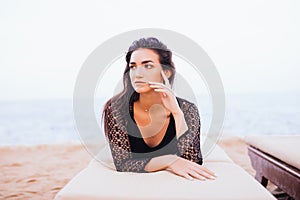 Beautiful woman lying on a deckchair at the sea beach