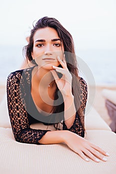 Beautiful woman lying on a deckchair at the sea beach