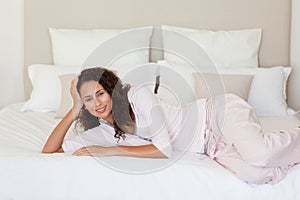 Beautiful woman lying down on her bed