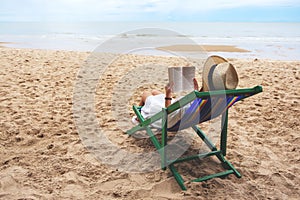 A beautiful woman lying down and reading book on the beach