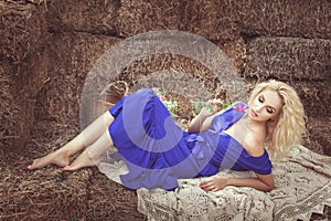 Beautiful woman lying in the hay.