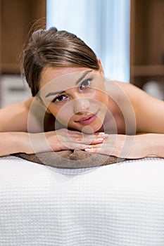 Beautiful woman lying on a massage table and relaxing